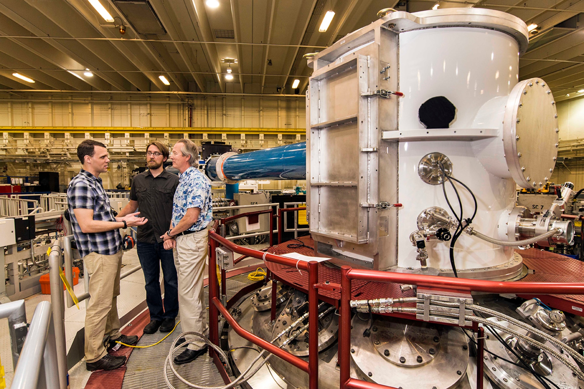 At the heart of Sandia National Laboratories’ Z machine, Matt Gomez, left, talks to Steve Slutz, far right, and Adam Sefkow, center. Gomez, Slutz and Sefkow are co-authors of a paper on recent fusion experiments. (Photo by Randy Montoya)