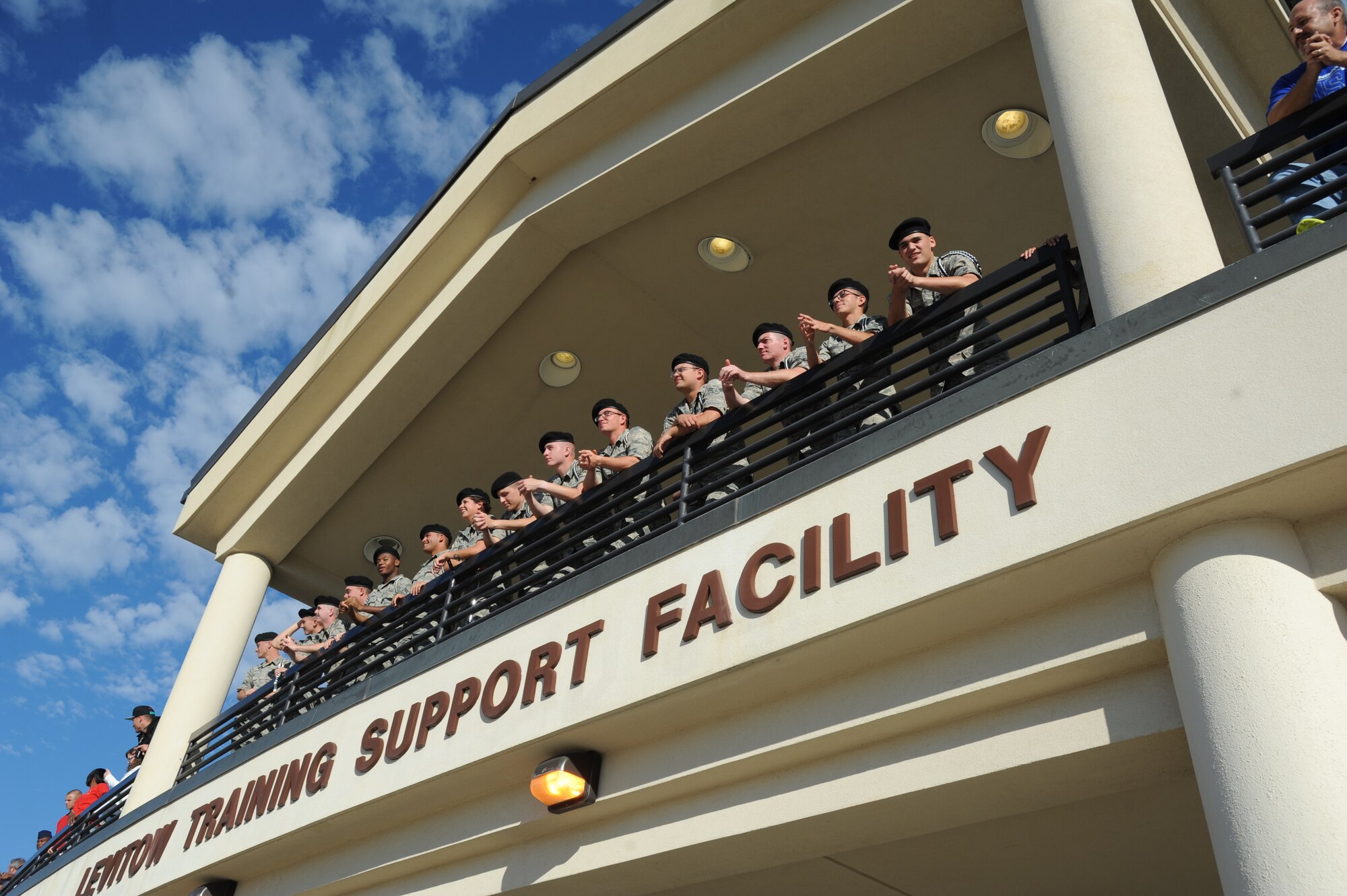 Members of the Drum and Bugle Corp. observe the performances from the Levitow Training Support Facility balcony during the 81st Training Group drill down Oct. 24, 2014, at the Levitow TSF Drill Pad, Keesler Air Force Base, Miss.  The Drum and Bugle Corp. performed for the audience throughout the competition. (U.S. Air Force photo by Kemberly Groue)