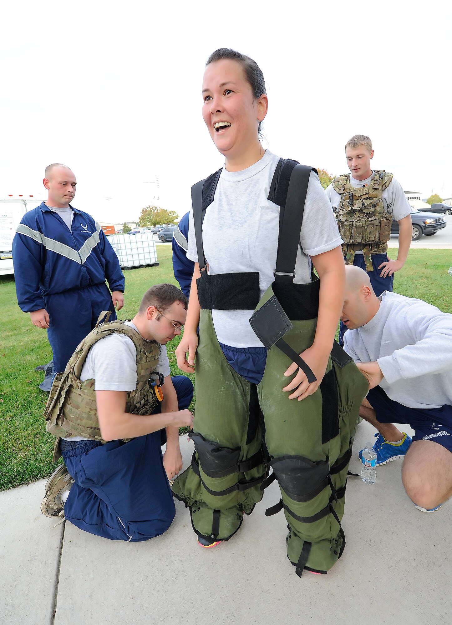 Tech. Sgt. Sue Bostic, 436th Civil Engineer Squadron bomb technician, smiles broadly as the EOD 9 bomb suit she is wearing is taken off her after she completed the 2014 Wingman Day 5K Fun Run on Oct. 24, 2014, at Dover Air Force Base, Del. Bostic wore the heavy suit during the entire length of the course. (U.S. Air Force photo/Greg L. Davis)