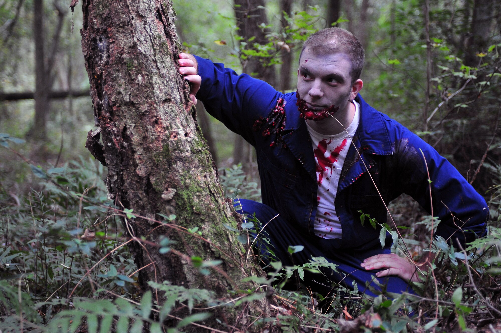 A zombie hides and waits for unsuspecting runners during a Zombie 5K at Seymour Johnson Air Force Base, North Carolina, Oct. 24. (U.S. Air Force photo/Senior Airman John Nieves Camacho)
