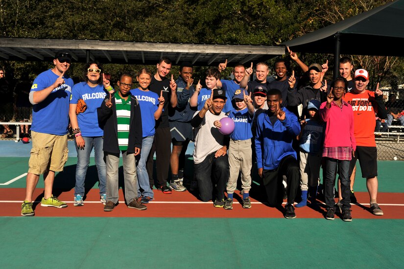 Airmen from the 437th Maintenance Squadron pose for a photo with their "buddies" after a Miracle League baseball game Oct. 25, 2014, in Summerville, S.C. The 437th Airlift Wing has been sponsoring the Falcon for the past three years, and different squadrons volunteer every Saturday during the 13-week season. The Miracle League is a league of special needs children who play baseball with the assistance of volunteer buddies. (U.S. Air Force photo/Staff Sgt. Renae Pittman)