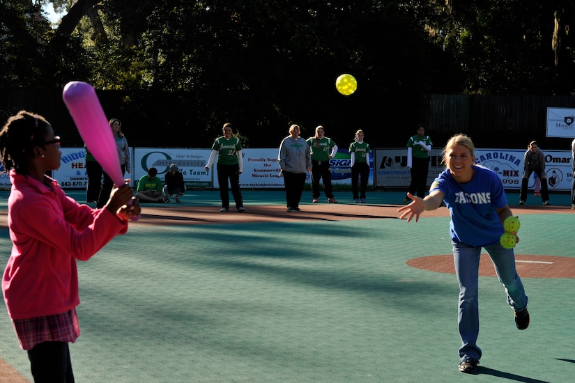 Senior Airman Shelby Redman, 437th Operations Support Squadron Airfield Management, tosses the baseball to Falcons team member Tamara during a Miracle League baseball game Oct. 25, 2014, in Summerville, S.C. Redman has been a coach for two years for the Falcons, a 437th Airlift Wing sponsored team. The Miracle League is a league of special needs children who play baseball with the assistance of volunteer buddies. (U.S. Air Force photo/Staff Sgt. Renae Pittman)