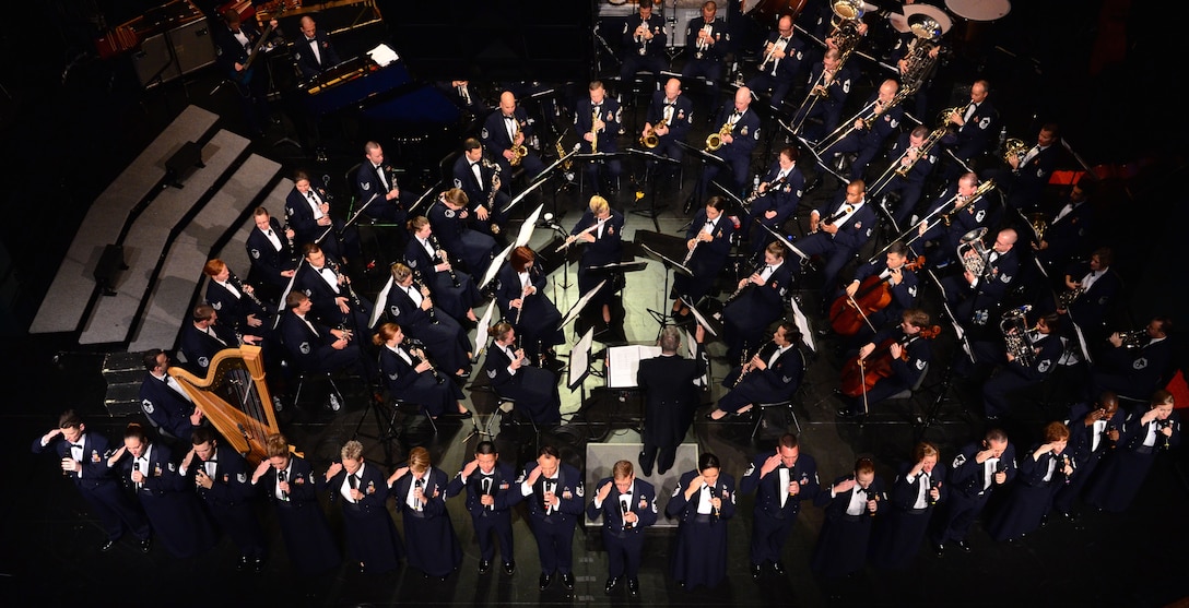 The Concert Band and Singing Sergeants perform and salute during their rendition of "An Honor to Serve" and "God Bless the USA" on tour at Flagler Auditorium in Palm Coast, Florida on October 18, 2014. (U.S. Air Force photo by Senior Master Sgt. Bob Kamholz/released)"