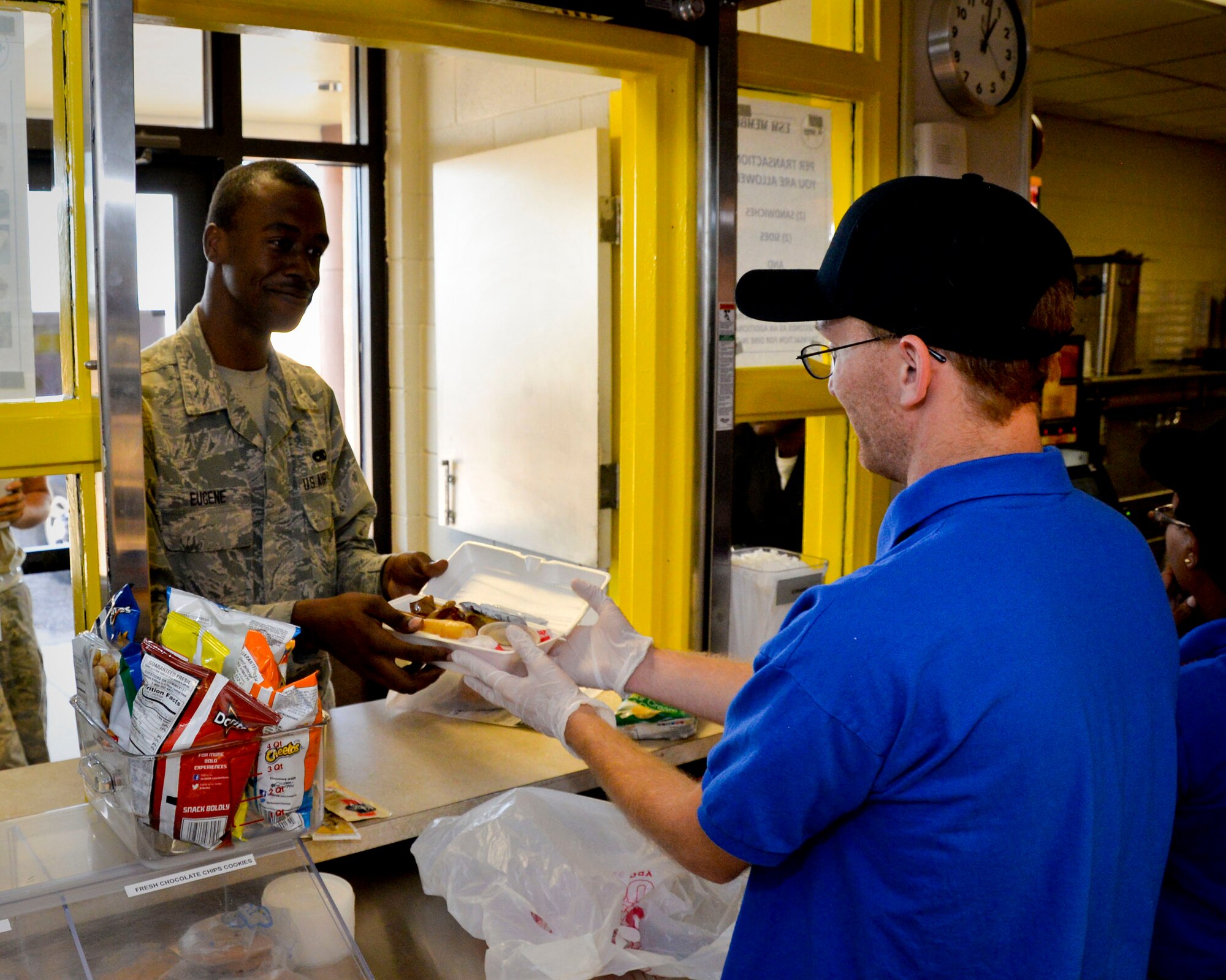 Airman 1st Class Carlton Eugene, 11th Aircraft Maintenance Unit weapons technician, picks up his lunch on Barksdale Air Force Base, La., Sept. 26, 2014. The Source's new and innovative system aims to provide flightline Airmen with a variety of items ranging from healthy options such as deli wraps to the more popular items such as their half-pound burgers in more time-efficient way. (U.S. Air Force photo/Airman 1st Class Mozer O. Da Cunha)

