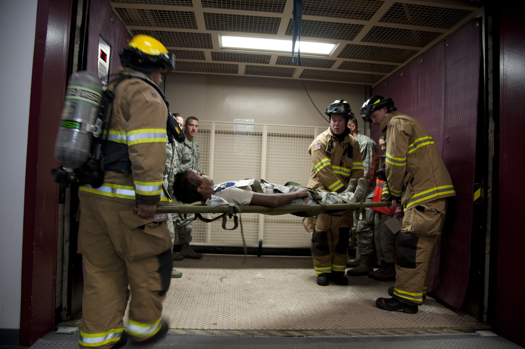CHEYENNE MOUNTAIN AIR FORCE STATION, Colo. — First responders transport three simulated casualties to the Cheyenne Mountain medical facility within the secured complex using an industrial elevator. This was all part of the Vigilant Shield exercise Oct. 20-26 where CMAFS team members responded to real-world scenarios that could take place within the mountain. (U.S. Air Force photo/Michael Golembesky)