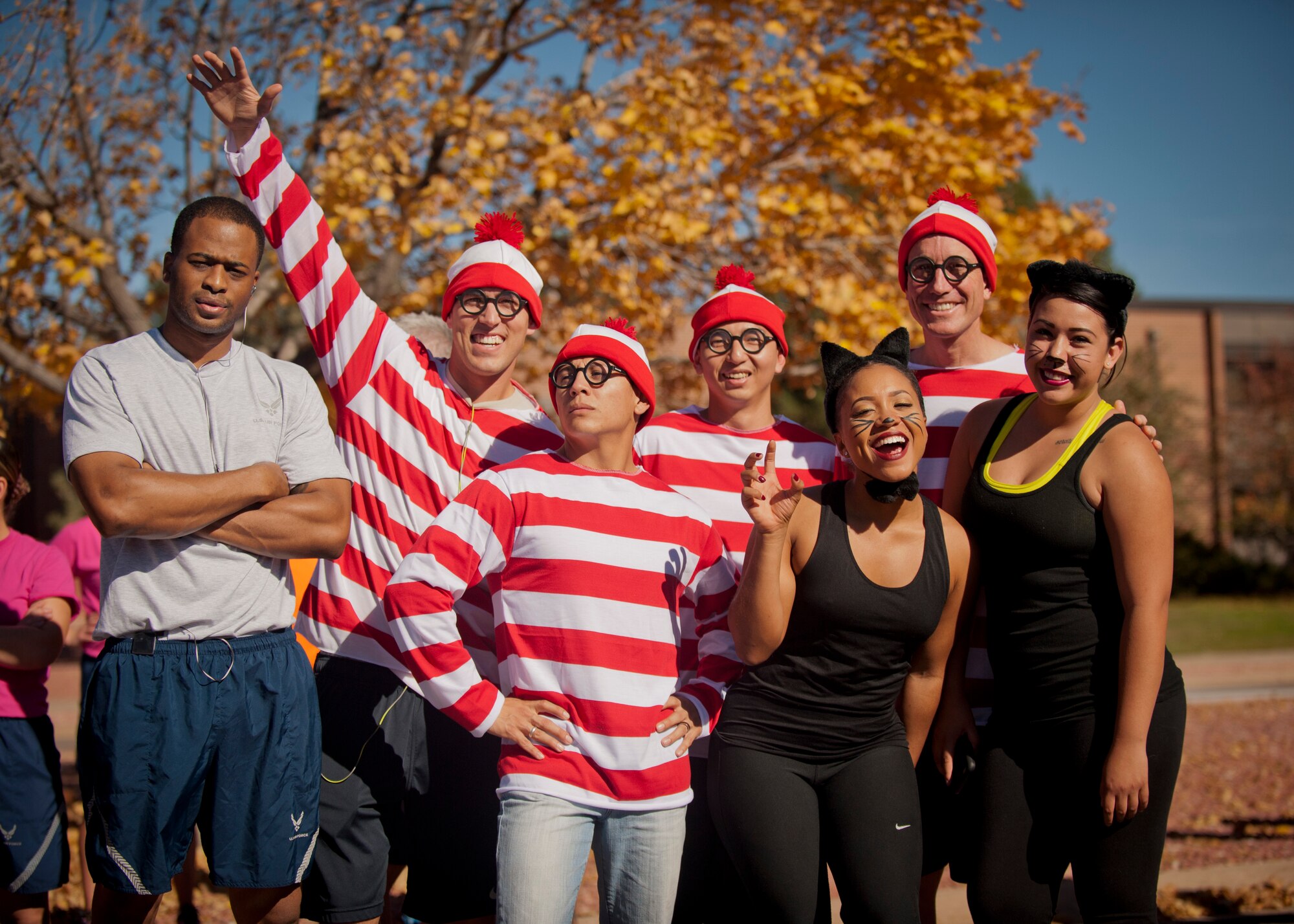 PETERSON AIR FORCE BASE, Colo. – A group of Waldos and cats from the 21st Medical Group pose for a photo just before the Spooky Warfit 5K Oct. 24. During the event those who dressed in costume not only ran a 5K but also completed several obstacles that lined the course. (U.S. Air Force photo/Staff Sgt. J. Aaron Breeden)