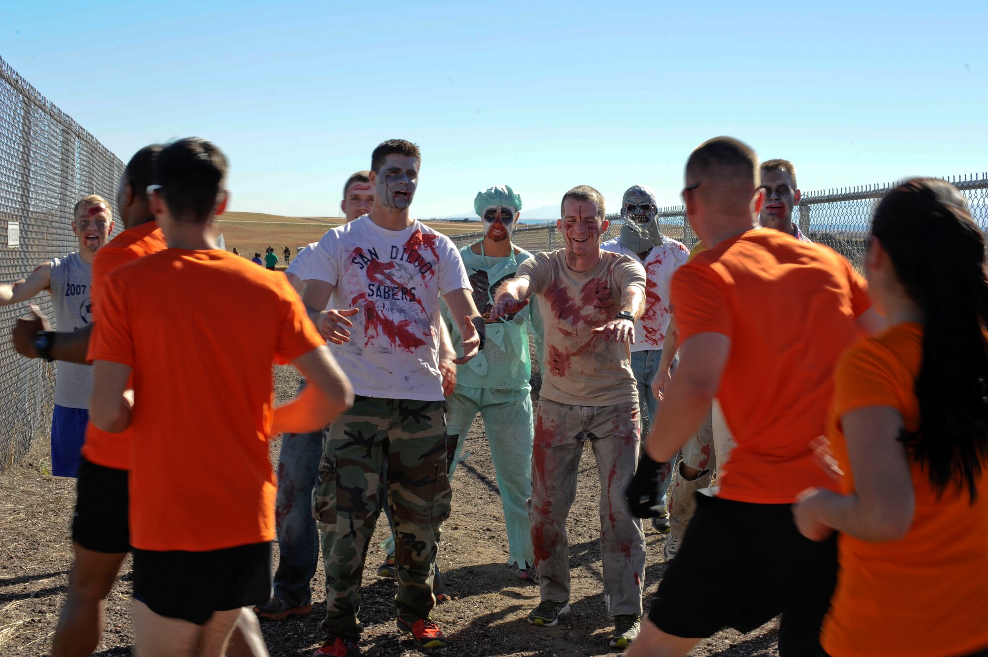 PETERSON AIR FORCE BASE, Colo. – Zombies try to get their next meal with each team that passes through their territory on the Spooky Warfit route Oct. 24. During the event those who dressed in costume not only ran a 5K but also completed several obstacles that lined the course. (U.S. Air Force photo/Airman 1st Class Rose Gudex)