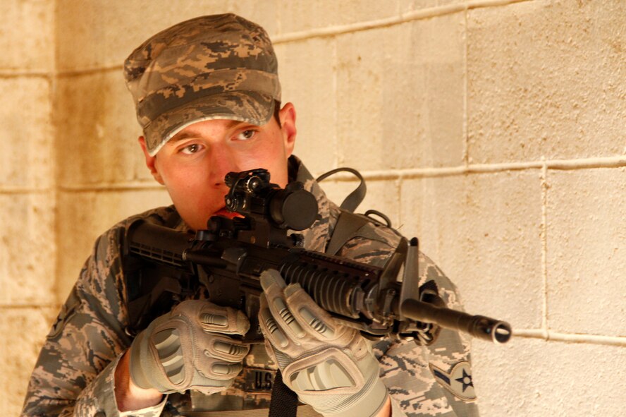 Airman Seven Raeburn, a fire team member with the 302nd Security Forces Squadron, gets ready to clear a room and engage possible threats Oct. 4, at Fort Carson, Colo. Around 45 members of the 302nd SFS participated field exercises in a Military Operations on Urban Terrain environment during the October Unit Training Assembly. (U.S. Air Force photo/Staff Sgt. Nathan Federico)