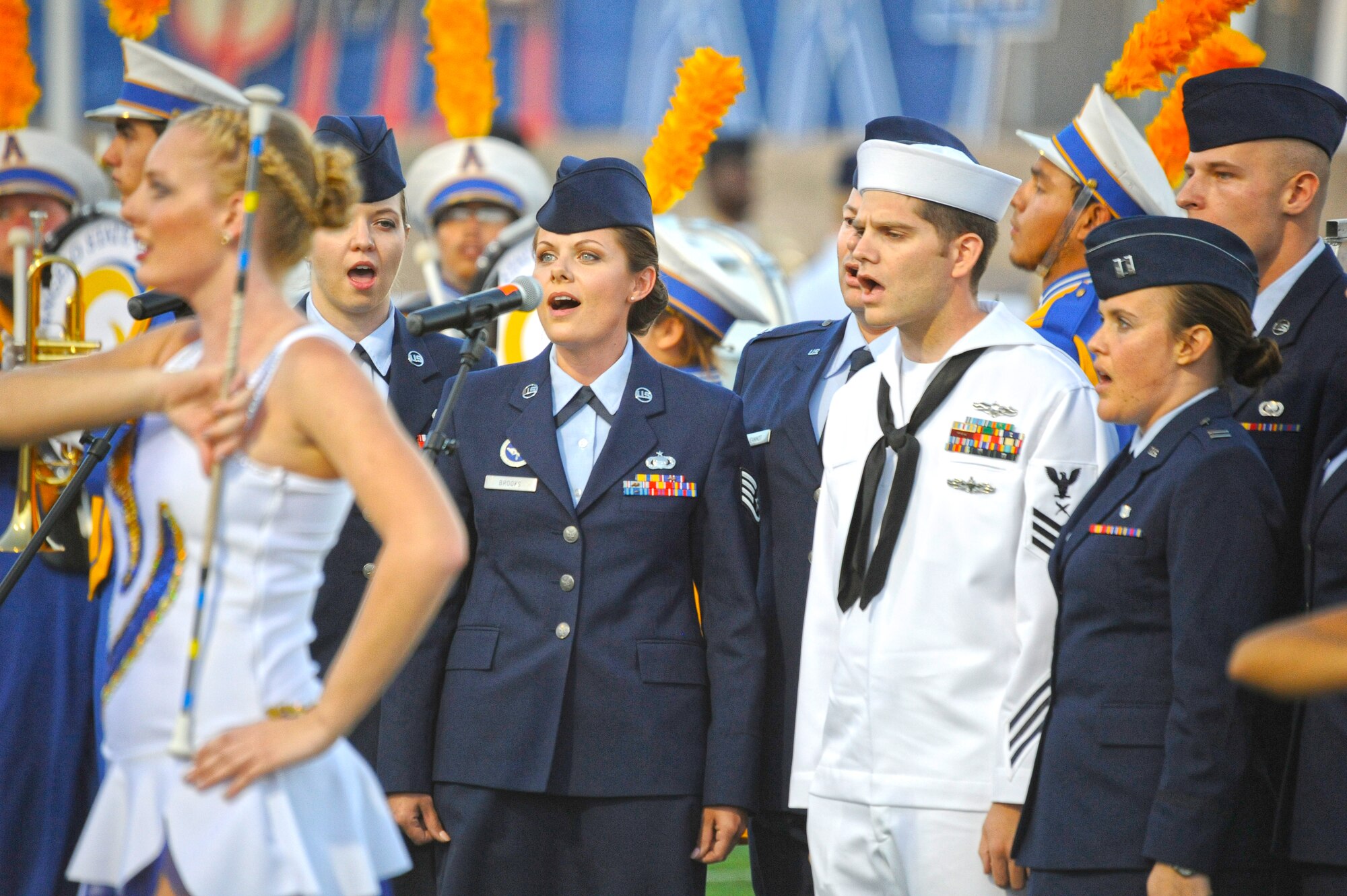 SAN ANGELO, Texas – Patriotic Blue sings the National Anthem as the Angelo State University marching band performs at the opening ceremony of ASU’s Military Appreciation Day Oct. 28. Patriotic Blue is a singing group of active duty service members from Goodfellow Air Force Base, 17th Training Wing. (U.S. Air Force photo/ Staff Sgt. Austin Knox)