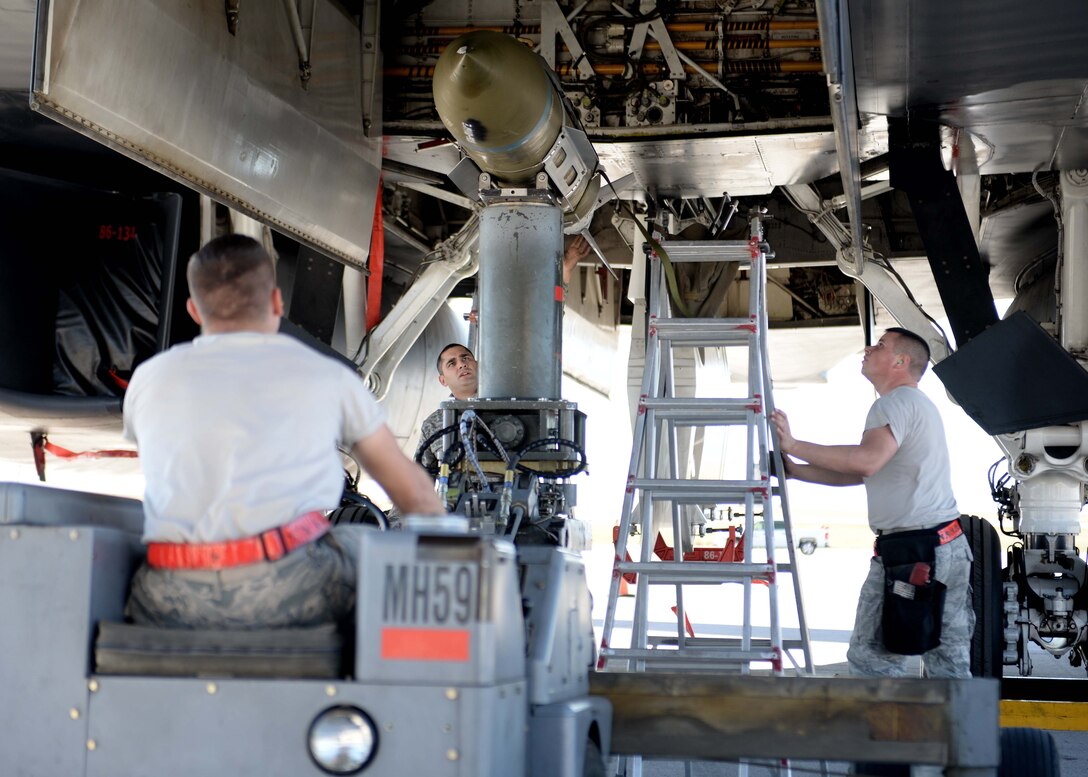 Members from the 34th Aircraft Maintenance Unit load crew mount a GBU 31 into a weapons bay of a B-1 bomber during the 2014 Load Crew Competition of the Year on the flightline at Ellsworth Air Force Base, S.D. Oct. 20, 2014. During the competition, teams loaded a GBU 38, GBU 31 and an AGM 158 munition within a 30 minute time frame. (U.S. Air Force photo by Airman 1st Class Rebecca Imwalle/Released)