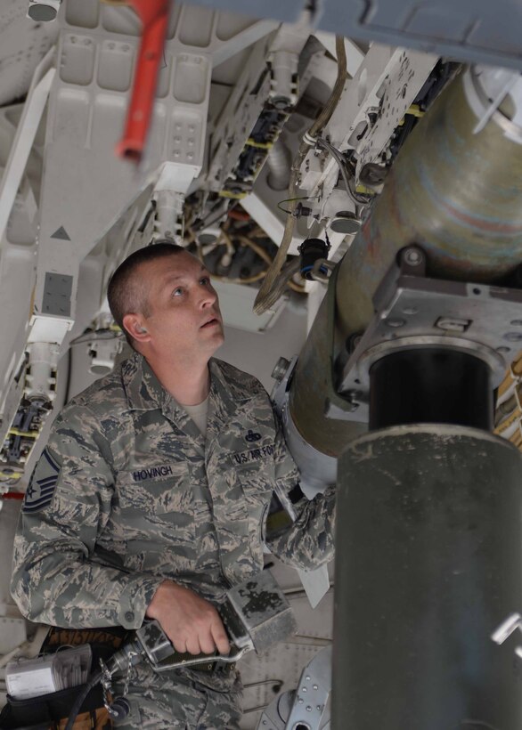 Master Sgt. Nicholas Hovingh, 37th Aircraft Maintenance Unit load crew member, inspects the alignment of a GBU 38 bomb during the 2014 Load Crew Competition of the Year on the flightline at Ellsworth Air Force Base, S.D. Oct. 20, 2014. During the competition, load crews from the 34th and 37th AMU were evaluated on their ability to safely, quickly and accurately load bombs onto a B-1 bomber. (U.S. Air Force photo by Airman 1st Class Rebecca Imwalle/Released)