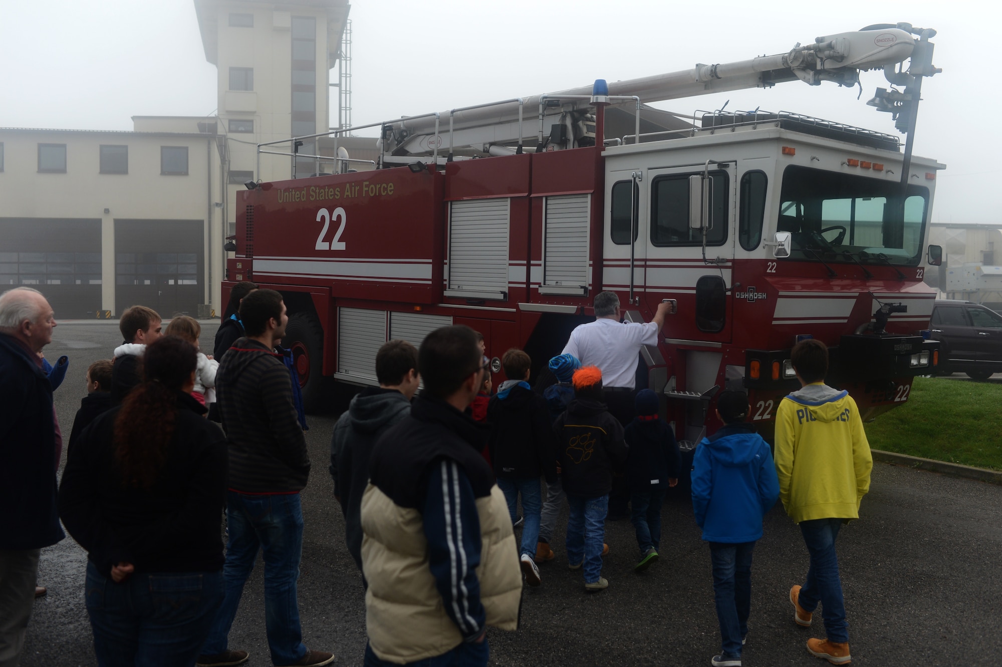 Junior firefighters from Luxembourg and their families tour a fire truck at the 52nd Civil Enginner Squadron fire station on Spangdahlem Air Base, Germany, Oct. 27, 2014. The Spangdahlem fire department hosts tours year-round and facilitates approximately one tour per week during the summer months. (U.S. Air Force photo by Senior Airman Gustavo Castillo/Released)