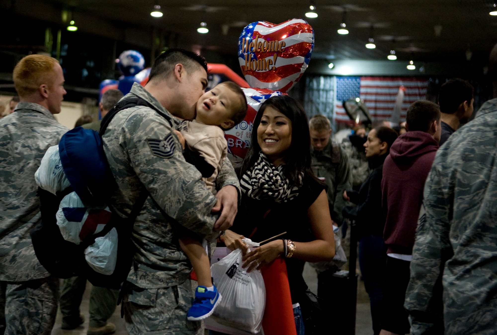U.S. Air Force Tech. Sgt. Johnathan Phipps, 35th Aircraft Maintenance Squadron propulsion specialist, is greeted by his family after returning from a deployment at Misawa Air Base, Japan, Oct. 25, 2014. The 35 AMXS provided safe, reliable aircraft, equipment, and munitions in support of overseas operations. (U.S. Air Force photo by Airman Jordyn Rucker/Released)