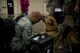 U.S. Air Force Master Sgt. Rodney Fodge, 35th Aircraft Maintenance Squadron lead production superintendent, is greeted by his dog after returning from a deployment at Misawa Air Base, Japan, Oct. 25, 2014. More than 100 pilots and maintainers deployed from Misawa to conduct air support missions in support of U.S. Air Forces Central Command operations. (U.S. Air Force photo by Airman Jordyn Rucker/Released)