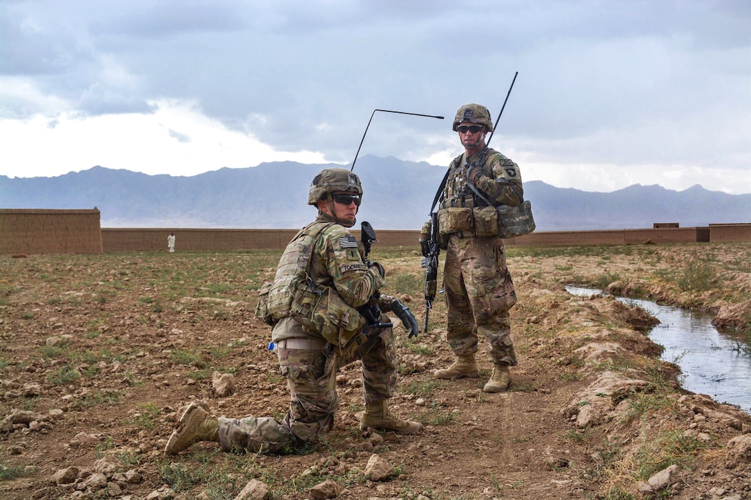 U.S. Army Staff Sgt. Robert Arrington, right, talks to U.S. Army Spc. Michael Berna after a patrol in the village of Kali Nasra in eastern Afghanistan, Oct. 13, 2014. Arrington, a senior scout, and Berna, a cavalry scout, are assigned to the 101st Airborne Division's 1st Squadron, 75th Cavalry Regiment.