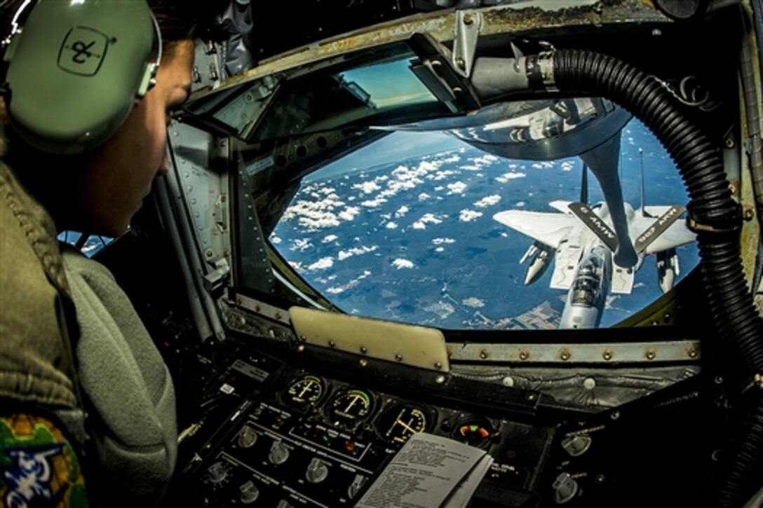 Air Force Senior Airman Crystal Cash refuels an F-15 during exercise Vigilant Shield 15 over the United States, Oct. 20, 2014. The annual exercise is designed to integrate Defense Department and civil response in support of the national strategy of aerospace warning and control, defense support of civil authorities and homeland defense.