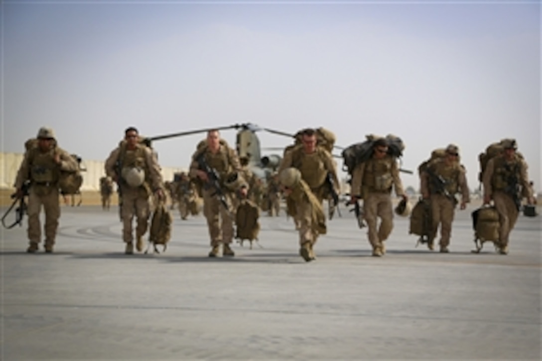 U.S. Marines exit a CH-46 Sea Knight helicopter on Kandahar Airfield in Afghanistan, Oct. 27, 2014. The Marines transitioned to Kandahar Airfield following the end of Regional Command operations in Helmand province.  
