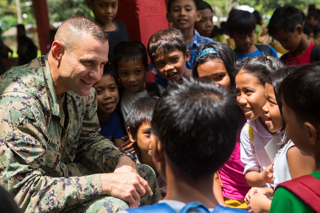 U.S. Marine Corps Col. John Armellino, chief of staff, 3rd Marine Expeditionary Brigade, speaks with local Philippine children during a community health engagement at San Rafael High School leading up to Amphibious Landing Exercise (PHIBLEX) 15 in Palawan, Philippines, September 26, 2014. PHIBLEX is an annual, bilateral training exercise conducted by the Armed Forces of the Philippines, U.S. Marines and Navy to strengthen interoperability across a range of capabilities to include disaster relief and contingency operations. (U.S. Marine Corps photo by Pfc. Matthew Casbarro/Released)