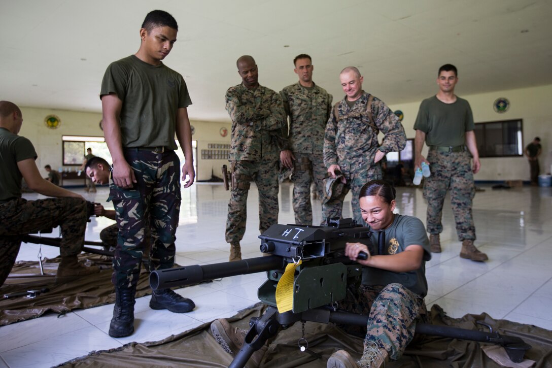 U.S. Marine Corps Cpl. Stephanie Becerril, embarkation specialist, with Marine Wing Support Squadron 172, Marine Aircraft Group 36 demonstrates how to functions check a Mark 19 grenade launcher during Amphibious Landing Exercise (PHIBLEX) 15 at Basa Air Base, Pampanga, Philippines, Oct. 2, 2014. PHIBLEX is an annual, bilateral training exercise conducted by the Armed Forces of the Philippines, U.S. Marines and Navy to strengthen interoperability across a range of capabilities to include disaster relief and contingency operations. (U.S. Marine Corps photo by MCIPAC Combat Camera Cpl. Sara A. Medina/RELEASED)