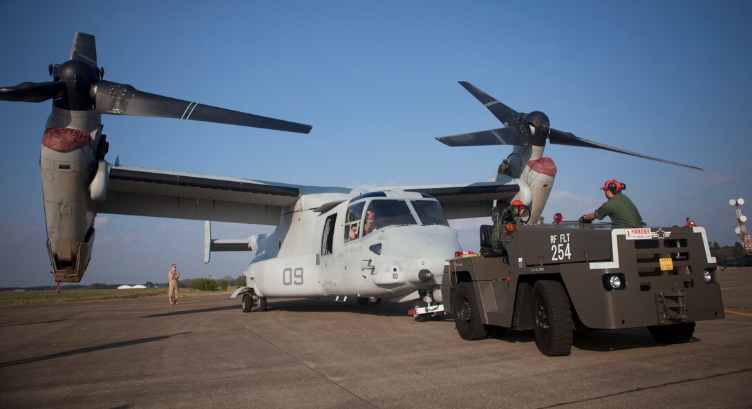 A member of the Japan Air Self Defense Force tows an MV-22B Osprey at Hyakuri Air Base during the Japan Air Self Defense Force’s Air Review 2014 Oct. 25. The aircraft is with Marine Medium Tiltrotor Squadron 265, Marine Aircraft Group 36, 1st Marine Air Wing, III Marine Expeditionary Force. 