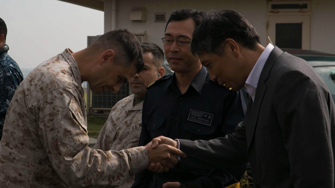 Maj. Giuseppe Stavale, from Cincinnati, Ohio, greets Hiroshi Marui, the director general with South Kanto Defense Bureau, Oct. 25 at Fleet Activities Yokosuka, Japan. Marines with Marine Medium Tiltrotor Squadron 265 showcased the MV-22 Osprey’s capabilities, so the Japanese can continue to learn about and familiarize themselves with the Osprey. Stavale is 1st Marine Aircraft Wing’s foreign area officer. The Marines are with Marine Aircraft Group 36, 1st MAW, III Marine Expeditionary Force. 