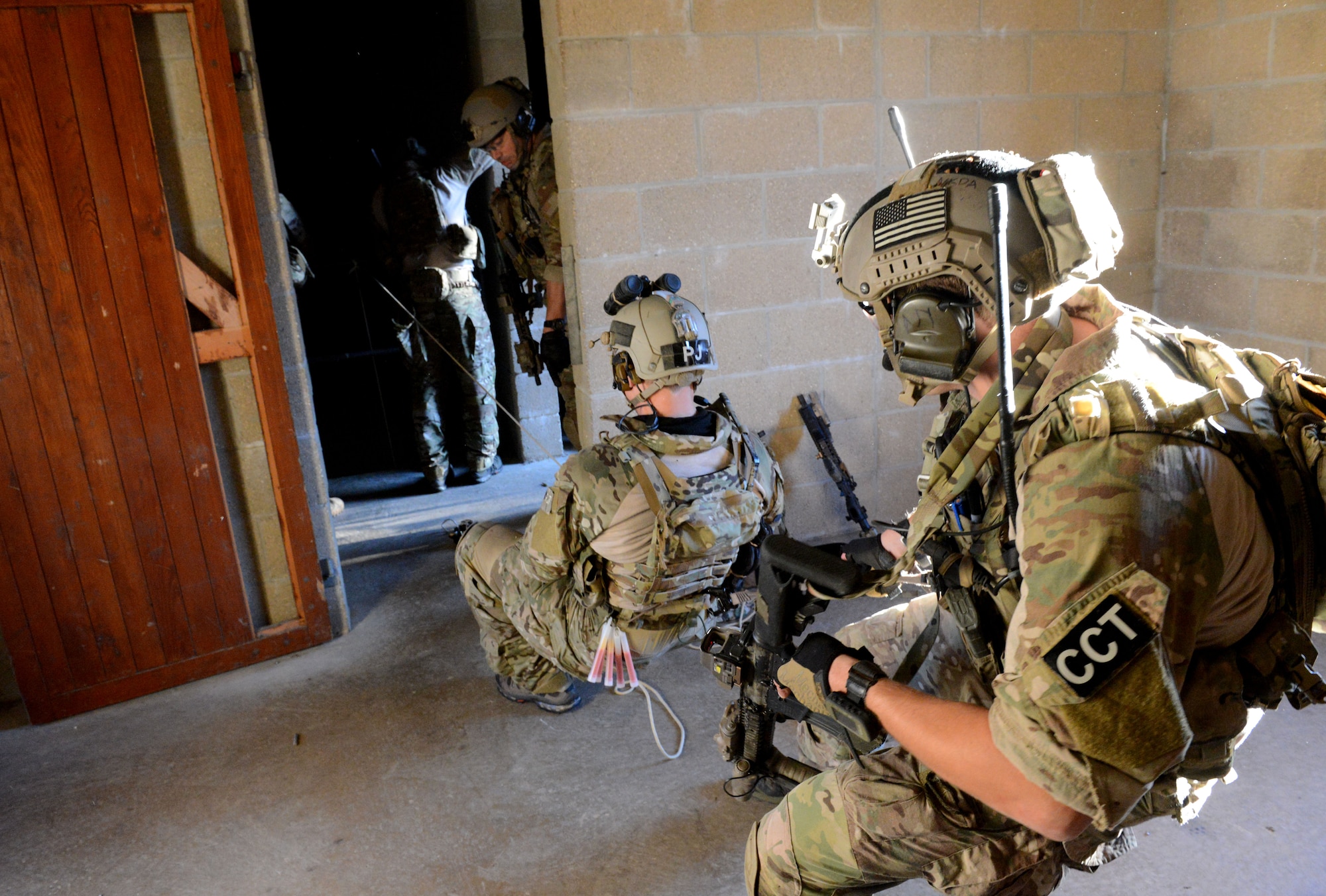 U.S. Air Force special tactics Airmen belay a fellow team member repelling to rescue a hostage in a simulated village under attack during a training exercise Oct. 7, 2014, at Stanford Training Area near Thetford, England. The exercise was designed to familiarize special tactics Airmen with combat scenarios preparing them for real-world incidents. (U.S. Air Force photo/Senior Airman Kate Maurer/Released)