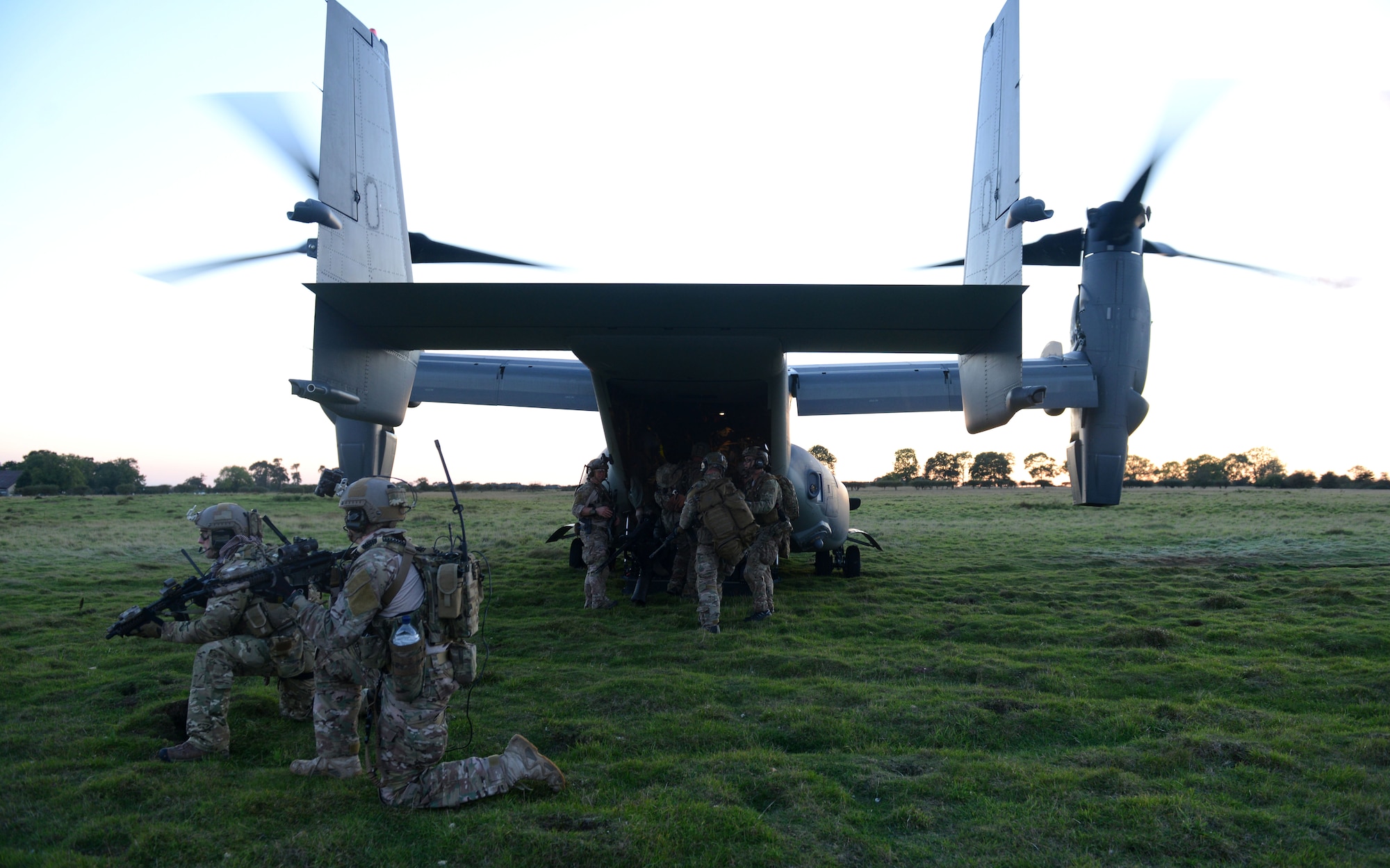 U.S. Air Force special tactics Airmen board a CV-22 Osprey leaving a simulated village previously under attack during a training exercise Oct. 7, 2014, at Stanford Training Area near Thetford, England. The exercise was designed to familiarize special tactics Airmen with combat scenarios preparing them for real-world incidents. (U.S. Air Force photo/Senior Airman Kate Maurer/Released)