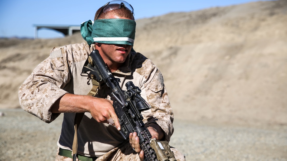U.S. Marine Sgt. Jonathan Overland clears a malfunction while blindfolded during a security element course aboard Camp Pendleton, Calif., Oct. 23, 2014. Overland is a military working dog handler with Combat Logistics Battalion 15, 15th Marine Expeditionary Unit. Marines in this course are preparing for the 15th MEU’s deployment in the spring. 