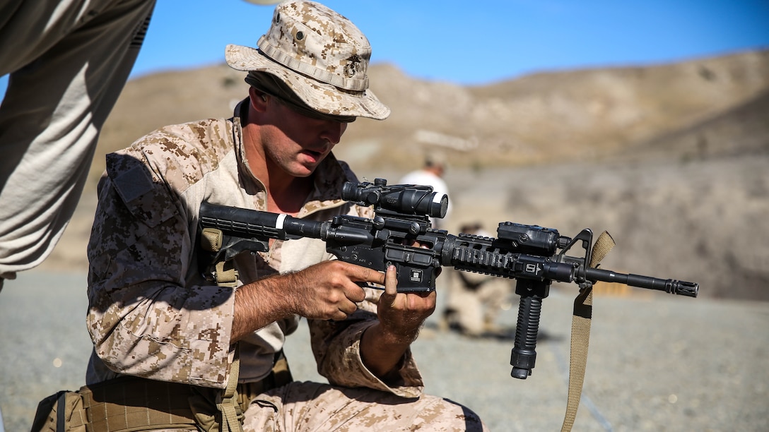U.S. Marine Cpl. Marc Plummer clears a malfunction during a security element course aboard Camp Pendleton, Calif., Oct. 23, 2014. Plummer is a military policeman with Combat Logistics Battalion 15, 15th Marine Expeditionary Unit. Marines in this course are preparing for the 15th MEU’s deployment in the spring. 