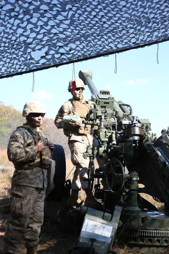 Field artillerymen with 3rd Battalion, 14th Marine Regiment, 4th Marine Division, prepare powder for an M777A2 Lightweight Howitzer before the next call for fire mission at Fort Indiantown Gap, Pa.,  during exercise Twisted Sister,  a battalion fire exercise, Oct. 25, 2014. Before the batteries can fire, the guns receive coordinates from forward observers down range who are the eyes and ears of the gun batteries. (Marine Corps Photo by Cpl. J. Gage Karwick/Released)