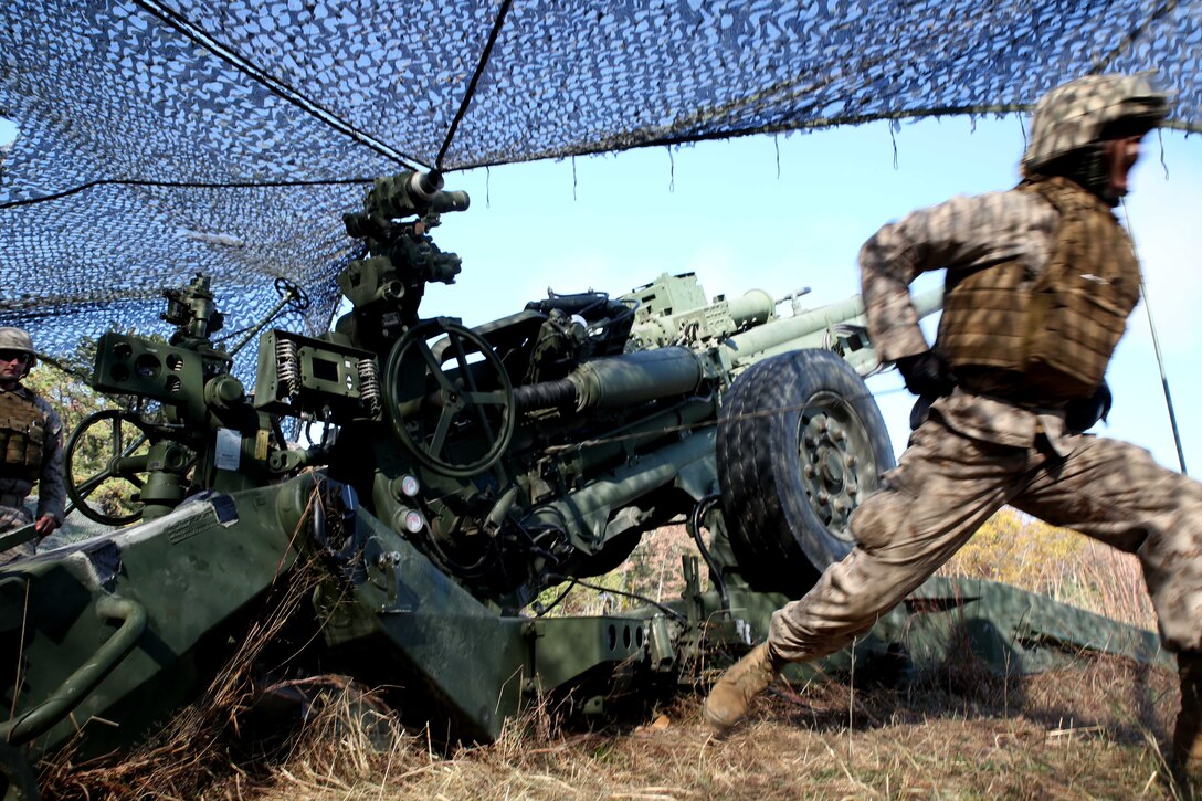 Lance Cpl. James Whearry, a field artilleryman with 3rd Battalion, 14th Marine Regiment, 4th Marine Division, fires the M777A2 Lightweight Howitzer at Fort Indiantown Gap, Pa.,  during exercise Twisted Sister, a battalion fire exercise at Fort Indiantown Gap, Pennsylvania, Oct. 25, 2014. Field artillerymen receive various call for fire scenarios, some requiring them to fire a certain number of rounds in a given time, others require precision shooting involving each gun in the battery as well as other batteries combined. (Marine Corps Photo by Cpl. J. Gage Karwick/Released)  