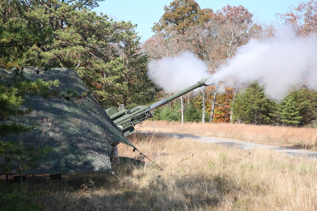 An M777A2 Lightweight Howitzer fires rounds down range as smoke from the barrel, commonly referred to as the dragon’s breath, clears from the area at Fort Indiantown Gap, Pa.,  during exercise Twisted Sister, a live-fire exercise conducted by 3rd Battalion, 14 the Marine Regiment, 4th Marine Division, Oct. 25, 2014. The howitzer is capable of providing accurate indirect fire at a distance of approximately 18 miles, with some variations reaching 25 miles.  (Marine Corps Photo by Cpl. J. Gage Karwick/Released)