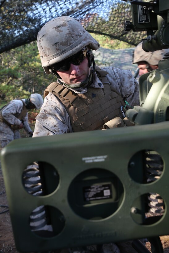 Cpl. Michael Coogan, a field artilleryman and a chief A-gunner with 3rd Battalion, 14th Marine Regiment, 4th Marine Division, rotates the angle of fire on an M777A2 Lightweight Howitzer before firing rounds down range at Fort Indiantown Gap, Pa.,  during exercise Twisted Sister,  a battalion fire exercise, Oct. 25, 2014. Before the batteries can fire, the guns receive coordinates from forward observers down range who are the eyes and ears of the gun batteries. (Marine Corps Photo by Cpl. J. Gage Karwick/Released)