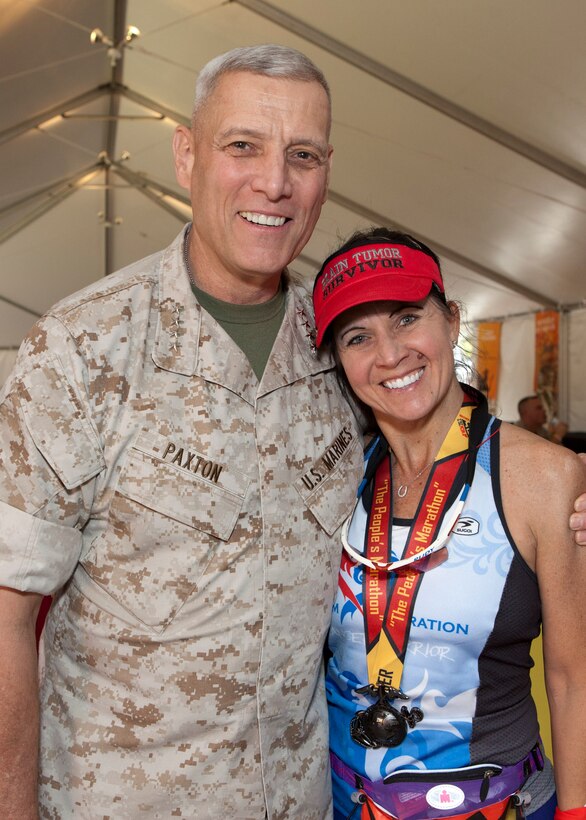 The Assistant Commandant of the Marine Corps, Gen. John M. Paxton, Jr., left, poses for a photo during the 39th Marine Corps Marathon, at the Marine Corps War Memorial, Arlington, Va., Oct. 26, 2014. The Marathon consisted of approximently 30,000 participants routing their way through Arlington, up Rock Creek Parkway, along the monuments and past the Pentagon, finishing at the Marine Corps War Memorial.  (U.S. Marine Corps photo by Cpl. Tia Dufour/Released)
