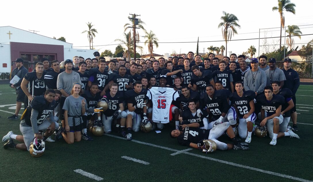 Frank Buncom IV, a Saint Augustine High School senior, proudly displays his Semper Fidelis Football Jersey in front of his teamates at a jersey presentation Oct. 20 in San Diego. Buncom is a model student and citizen. He maintains a 4.0 grade point average, participates in the associated student body council and is on the Saint Augustine principal’s list. Buncom is also an active member of the community through volunteer work with Young Christians Making a Difference organization (www.youngcmd.org), is a member of the Loyal Sons of Saint Augustine and has received the Rotary Youth Leadership Award. He was also named homecoming king. “[Buncom] is the best player I have ever coached in 20 years in regard to character and leadership qualities,”said Richard Sanchez, Saint Augustine High School head coach.
