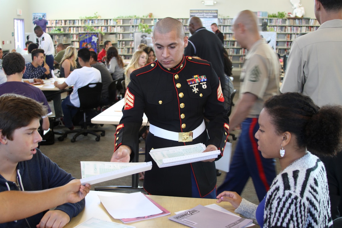 Sgt. Eddie Quezada, a Marine Corps recruiter from Marine Corps Recruiting Station San Diego, gathers answer key sheets during Mission Bay High School’s first Armed Services Vocational Aptitude Battery in San Diego, Oct. 23. Marine Corps, Army and Navy Recruiters proctored the four-hour exam. The test covers a variety of skillsets and measures developed abilities to help predict future academic and occupational attainment in the military. Students are expected to receive their results in approximately two weeks. For more information on taking an ASVAB please contact your local military recruiter.