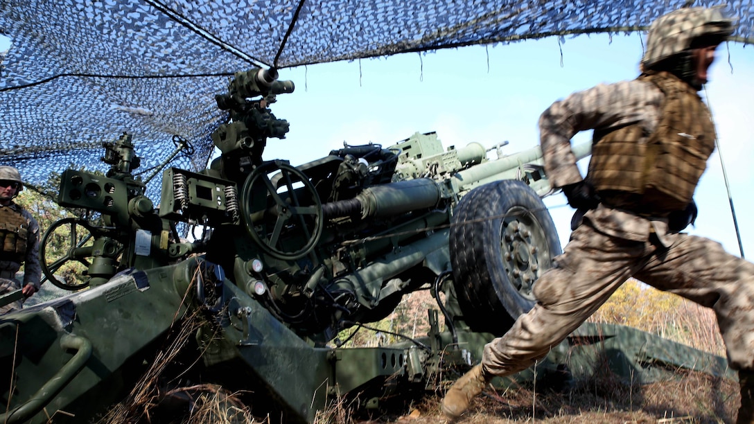 Lance Cpl. James Whearry, a field artilleryman with 3rd Battalion, 14th Marine Regiment, 4th Marine Division, fires the M777A2 Lightweight Howitzer at Fort Indiantown Gap, Pa.,  during exercise Twisted Sister, a battalion fire exercise at Fort Indiantown Gap, Pa., Oct. 25, 2014. Field artillerymen receive various call for fire scenarios, some requiring them to fire a certain number of rounds in a given time, others require precision shooting involving each gun in the battery as well as other batteries combined. 
