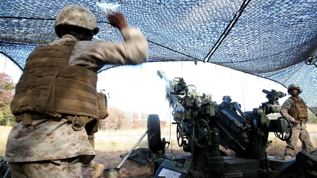 Sgt. Julian Gomez III, a section chief with 3rd Battalion, 14th Marine Regiment, 4th Marine Division, gives the command to fire an M777A2 Lightweight Howitzer to Lance Cpl. James Whearry, a field artilleryman with 3rd Bn. 14th Marines, at Fort Indiantown Gap, Pa., during exercise Twisted Sister, a battalion fire exercise, Oct. 25, 2014. Field artillerymen receive various call-for-fire scenarios, some requiring them to fire a certain number of rounds in a given time, others require precision shooting involving each gun in the battery as well as other batteries combined. 