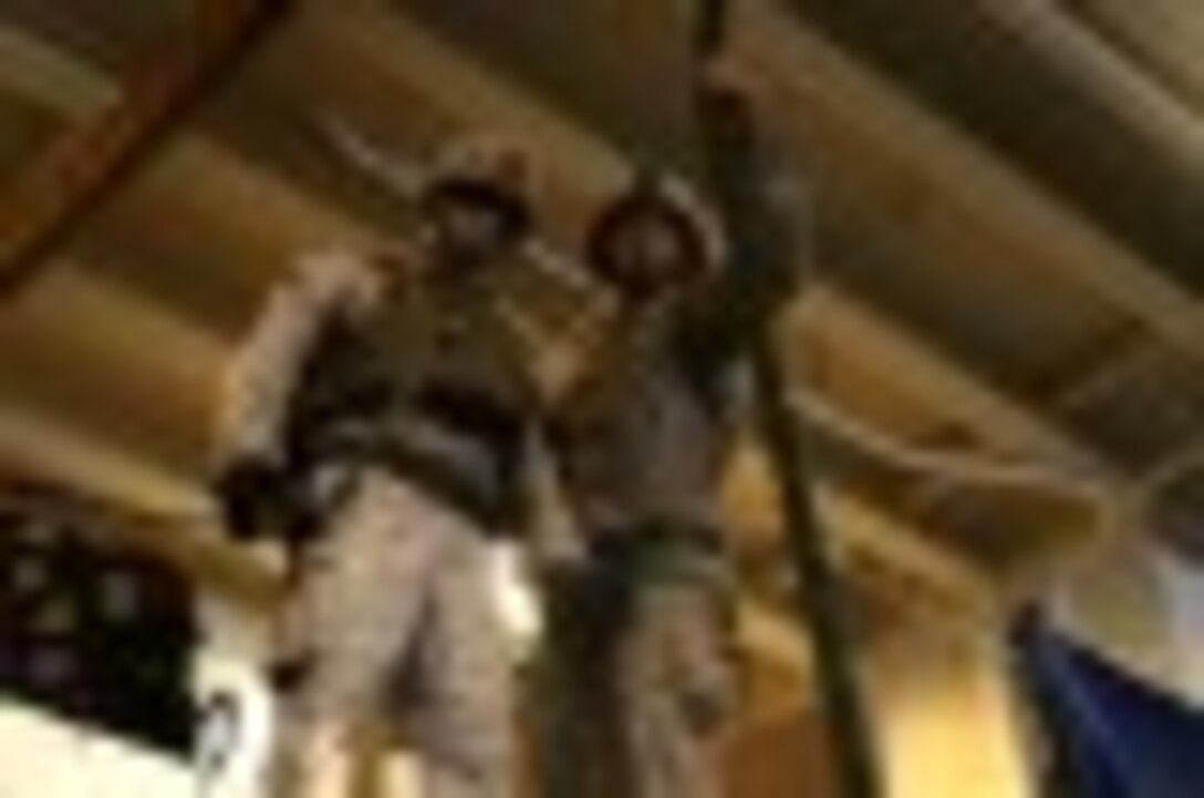 1st Lt. Jake Lunsford, left, a platoon commander with Fox Company, Battalion Landing Team 2nd Battalion, 1st Marines, 11th Marine Expeditionary Unit (MEU), prepares to jump during fast rope drill aboard the Makin Island, Oct. 26.  The Makin Island Amphibious Ready Group (ARG) and the embarked 11th MEU are deployed in support of maritime security operations and theater security cooperation efforts in the U.S. 5th Fleet area of responsibility. (U.S. Marine Corps photos by Cpl. Demetrius Morgan/ Released) 
