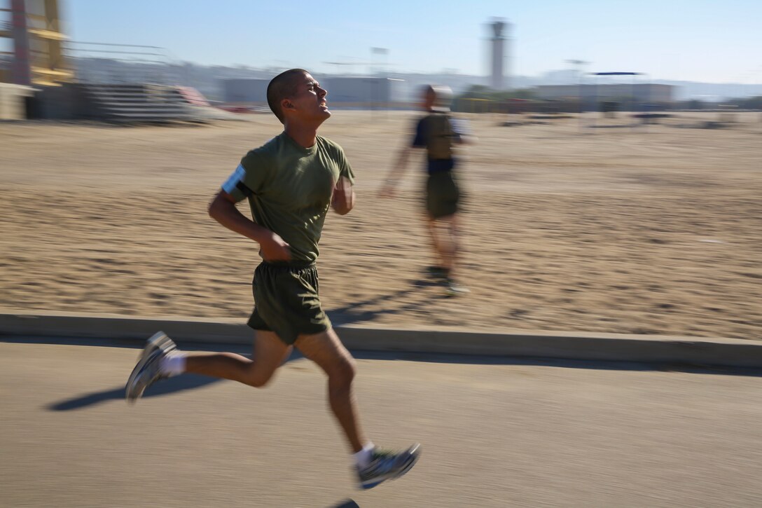A recruit of India Company, 3rd Recruit Training Battalion, sprints to the finish line during the three-mile run portion of the final Physical Fitness Test aboard Marine Corps Recruit Depot San Diego, Oct. 23.  To achieve a perfect score on the run, recruits needed to finish in 18 minutes or less.