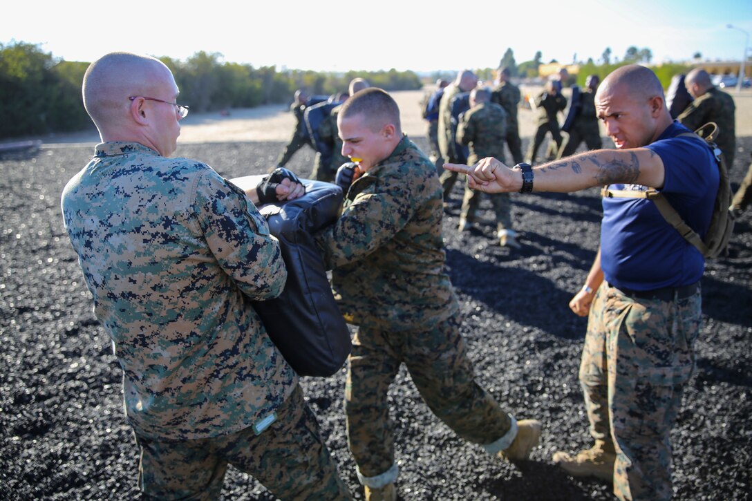 Sgt. Juan C. Silva, drill instructor, Platoon 3231, Kilo Company, 3rd Recruit Training Battalion, instructs a recruit to strike with intensity during the Intro to the Marine Corps Martial Arts Program class aboard Marine Corps Recruit Depot San Diego, Oct. 22.  At the conclusion of recruit training, recruits will become a basically trained fighter with opportunities to continue and develop their training in MCMAP later on.   