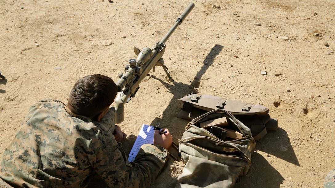 A Marine plots data after engaging a target during the pre-scout sniper course Oct. 27, 2014.  1st Marine Division schools recently began the second week of training for Marines attending the pre-scout sniper course aboard Camp Pendleton California.