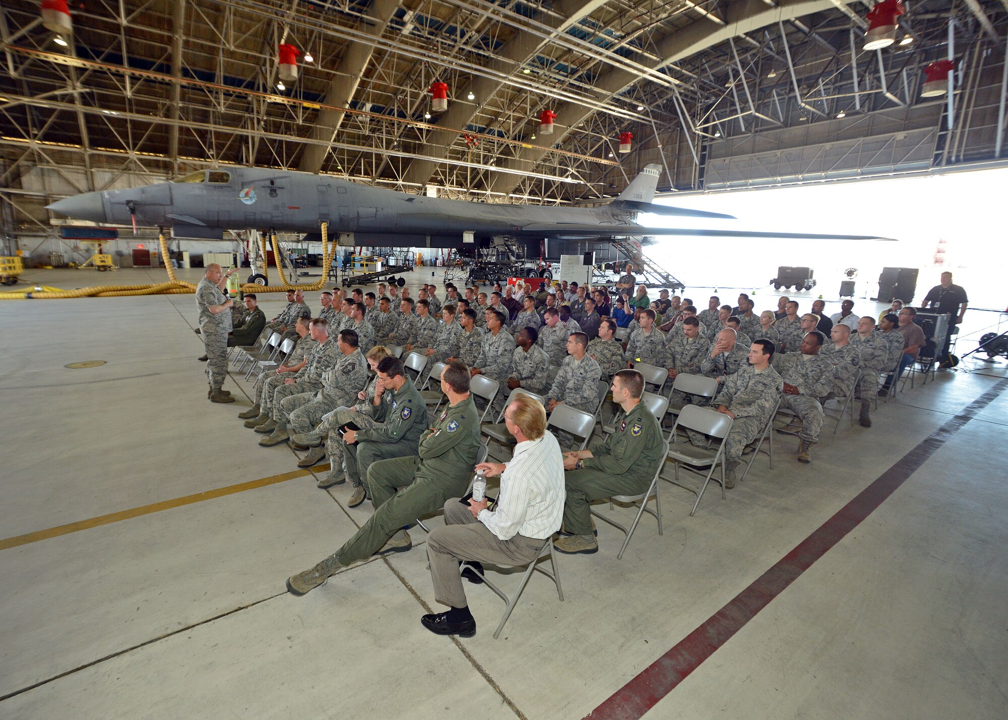 Brig. Gen. Michael Brewer, 412th Test Wing commander, addresses personnel from the 416th Flight Test Squadron and the 445th FLTS during a commander’s call held Oct. 23 in Hangar 1210 to initially discuss what will be the consolidation of the two historic squadrons into one. (U.S. Air Force photo by Jet Fabara)