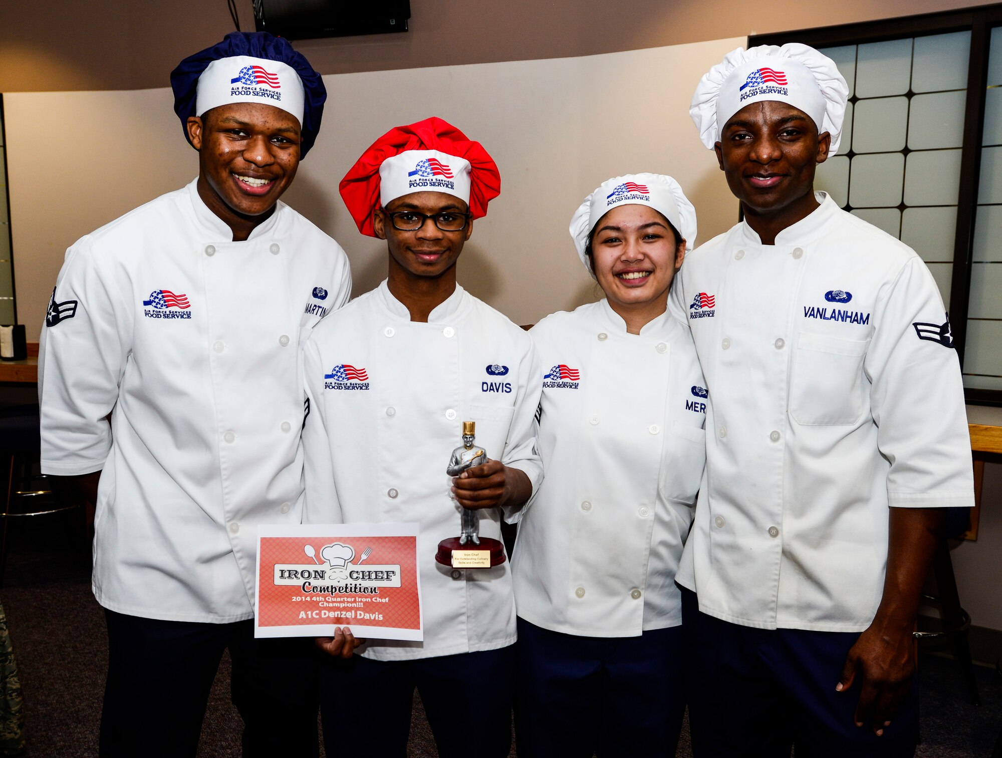 Team Davis celebrates its win during a quarterly cooking competition at the Two Seasons Dining Facility, Eielson Air Force Base, Alaska, Oct. 24, 2014. Team Davis received the title of Iron Chef of the Quarter, a team trophy and a one-day pass. (U.S. Air Force photo by Senior Airman Racheal E. Watson/Released)