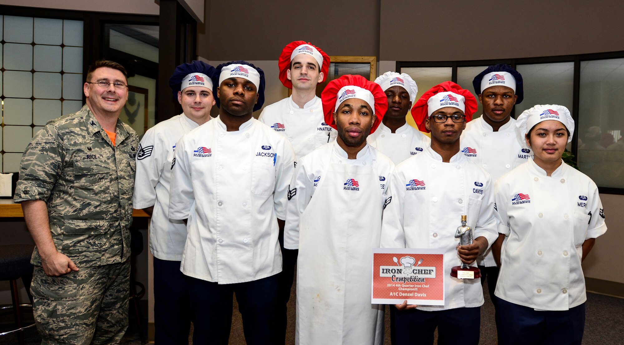 U.S. Air Force Col. Larry Rice, the 354th Mission Support Group commander, poses with Team Lee and Team Davis at the Two Seasons Dining Facility, Eielson Air Force Base, Alaska, Oct. 24, 2014, during a cooking competition. Team Davis won ultimate bragging rights and was recognized as Eielson’s Iron Chef of the Quarter in the two-team of the kitchen. (U.S. Air Force photo by Senior Airman Racheal E. Watson/Released)