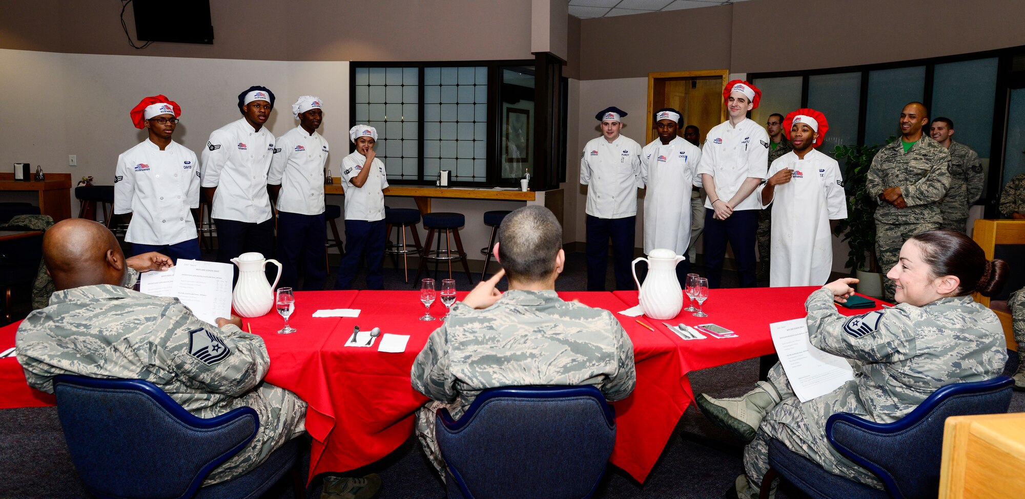 U.S. Air Force Airmen with Team Lee and Team Davis receive constructive criticism at the Two Seasons Dining Facility, Eielson Air Force Base, Alaska, Oct. 24, 2014, during the Eielson Iron Chef of the Quarter cooking competition. Each team presented its dishes in order of appetizers, entrées and desserts. (U.S. Air Force photo by Senior Airman Racheal E. Watson/Released)