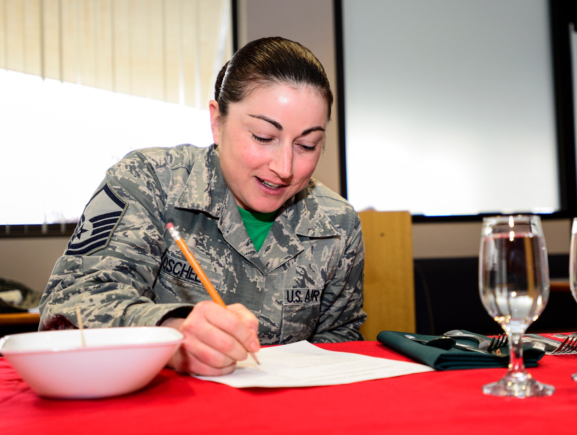 U.S. Air Force Master Sgt. Holly Roschel, an Eielson Iron Chef of the Quarter cooking competition judge, scores and comments her dish at the Two Seasons Dining Facility, Eielson Air Force Base, Alaska, Oct. 24, 2014. Judging criteria included appeal, compatibility, color, creativity, originality and garnishing. (U.S. Air Force photo by Senior Airman Racheal E. Watson/Released)
