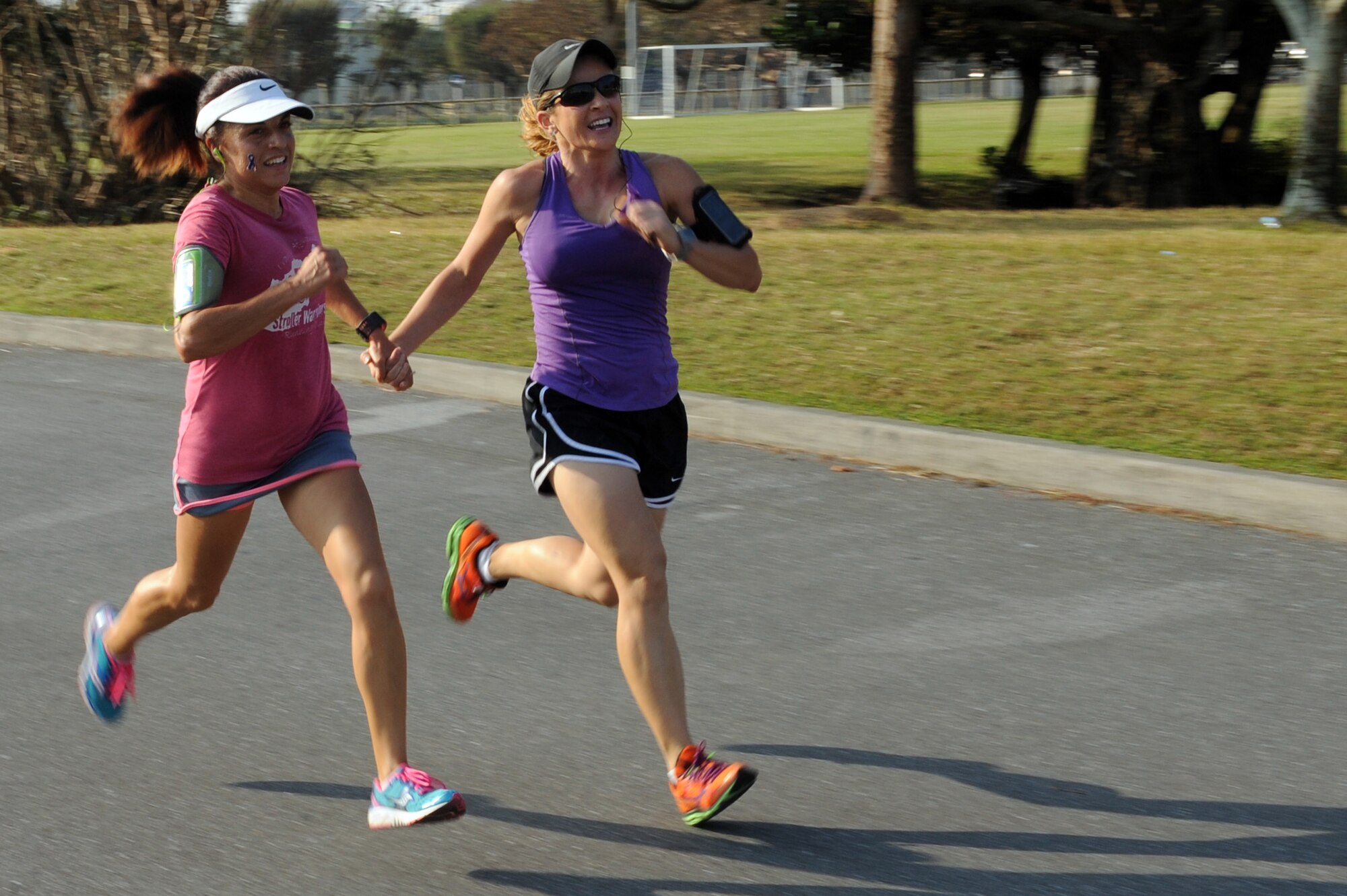 Nikoleta Spears, left, and Kasse Calderon, right, both U.S. Marine Corps dependents, tie for third place during Kadena Family Advocacy's "Take a Stand Against Domestic Violence" 5K on Camp Lester, Japan, Oct. 25, 2014. The 5K was held in support of Domestic Violence Awareness Month, which has been observed each October since 1989. (U.S. Air Force photo by Airman 1st Class Zade C. Vadnais/Released)