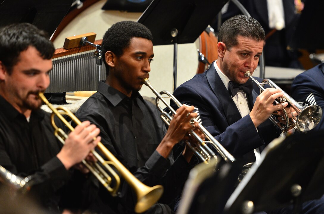 Master Sergeant Christian Pagnard performs with two trumpet students in Pensacola, Florida.  As part of our Advancing Innovation through Music (AIM) program, students from many schools had the opportunity to perform with the band.  This performance was a part of the Concert Band and Singing Sergeants' Fall Tour 2014 which took them through parts of Alabama, Florida, and Georgia. (U.S. Air Force Photo by Senior Master Sgt Bob Kamholz/released)