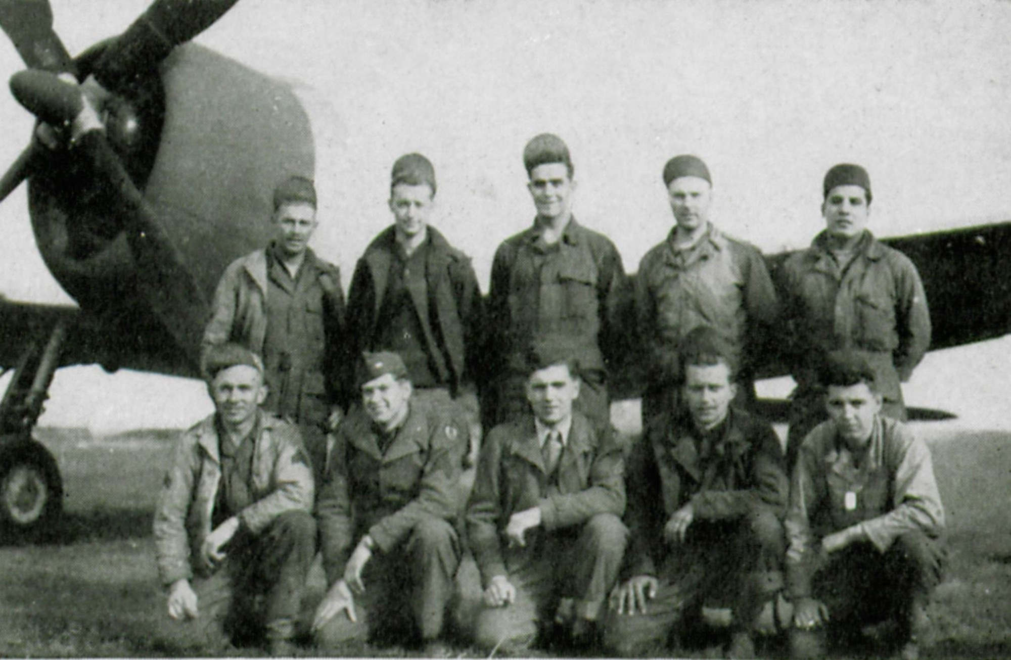 Corporal Robert H. Lindsay, 405th Fighter Squadron Armorer seen here standing, fourth man from the left, witnessed the lucky return of Major John Leonard, who was shot down by “friendly fire” during a supply drop mission for the Lost Battalion.  He told of the Major’s encounter with the anti-aircraft gunners who shot him down.  Other men pictured are, from left to right, standing, Charles D. Stebbins, Harold J. Baker, Jack P. Starr and at far right, Louis Lopez.  Kneeling are Clyde C. Arthurs, John M. Mann, Gerald E. Kinter, Francis J. Flinn and Ezra W. O’Connor.  (The Story of the 371st Fighter Group in the E.T.O., page 126)